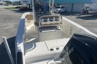 Slide: The Image of 2022 Trophy T22 boat with Mercury engine, docked outdoors in a sunny setting. - 11