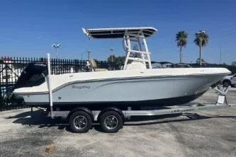 Slide: The Image of 2022 Trophy T22 boat on trailer, parked outdoors under clear sky. - 2
