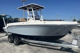 Slide: The Image of 2022 Trophy T22 boat on trailer, parked outdoors under clear blue sky. - 3