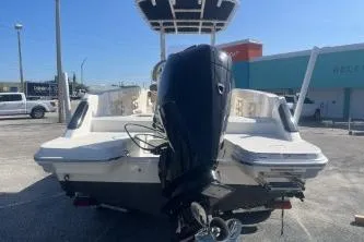 Slide: The Image of 2022 Trophy T22 boat with outboard motor, parked outdoors on a sunny day. - 5