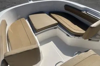 Slide: The Image of 2022 Trophy T22 boat interior with beige cushioned seating. - 8