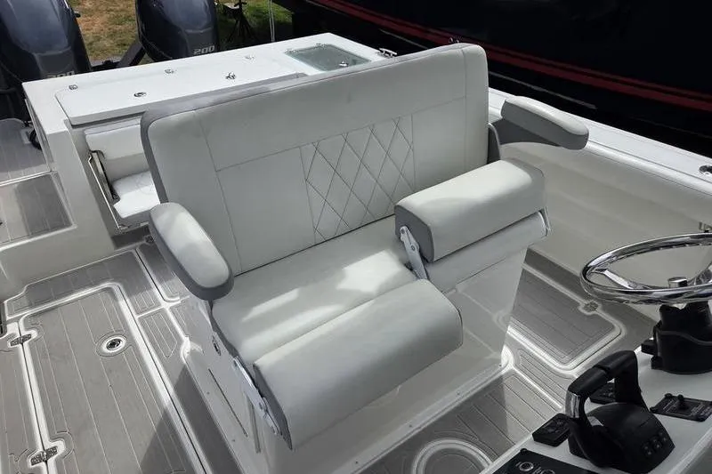Slide: The Image of 2023 Parker 2600 Center Console boat interior with cushioned seating and steering wheel. - 12