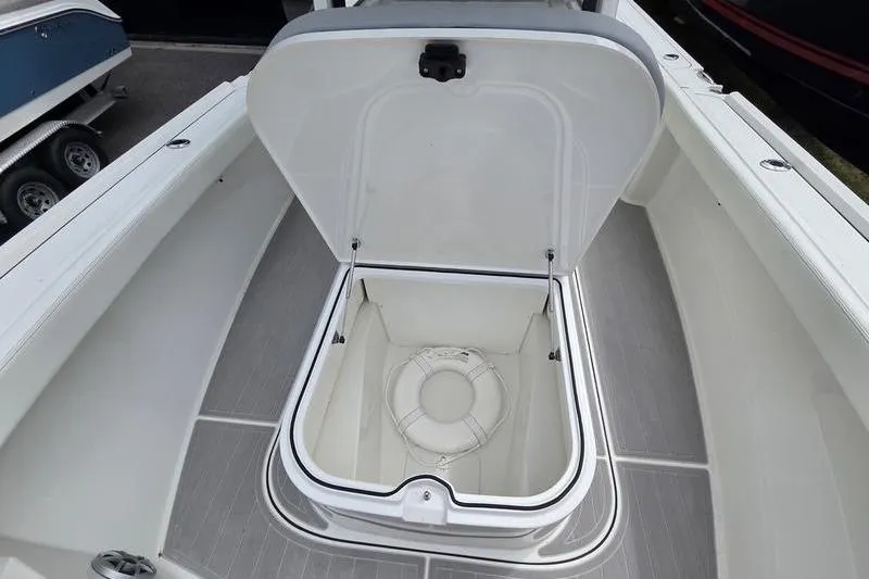 Slide: The Image of 2023 Parker 2600 Center Console boat with open storage compartment and life ring. - 15