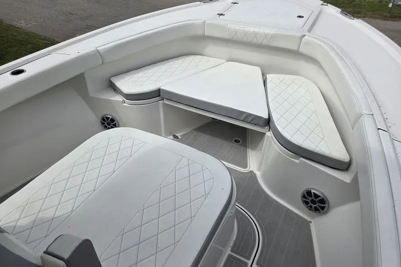 Slide: The Image of 2023 Parker 2600 Center Console boat interior with cushioned seating and speakers. - 17