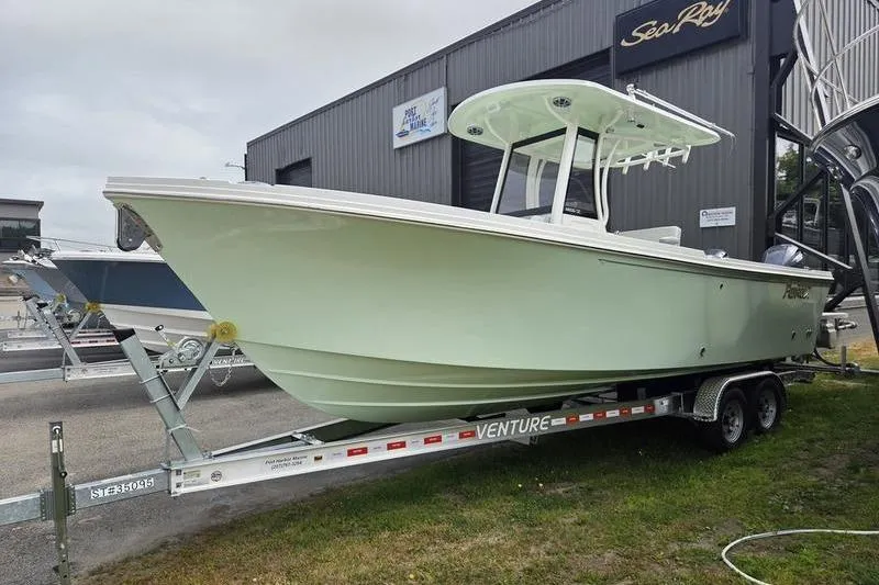 Slide: The Image of 2023 Parker 2600 Center Console boat on trailer, displayed outdoors. - 2