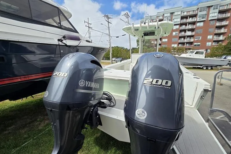 Slide: The Image of 2023 Parker 2600 Center Console with twin Yamaha 200 engines, docked near buildings. - 6