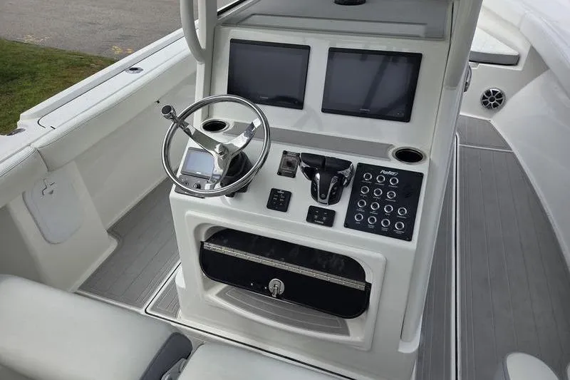 Slide: The Image of 2023 Parker 2600 Center Console boat dashboard with dual screens and steering wheel. - 7