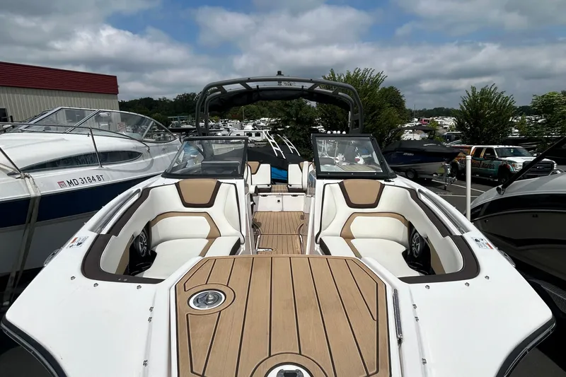 Slide: The Image of 2021 Yamaha Boats 252S with sleek interior design and spacious seating, displayed outdoors. - 5