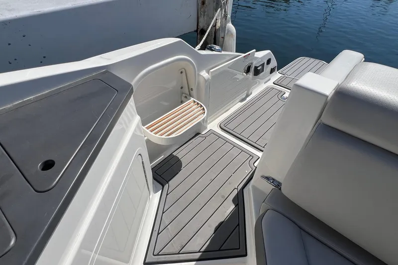 Slide: The Image of 2021 Sea Ray SDX 290 boat interior with sleek seating and modern deck design. - 12