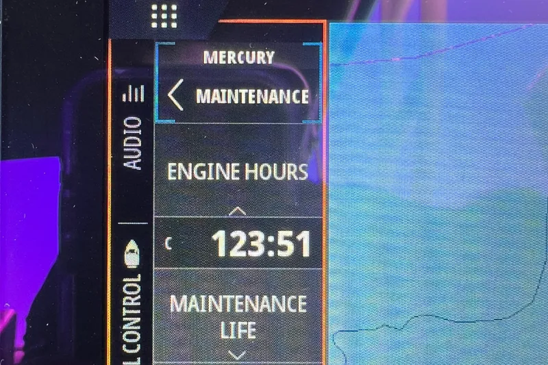 Slide: The Image of 2021 Sea Ray SDX 290 dashboard showing 123:51 engine hours in maintenance mode. - 14