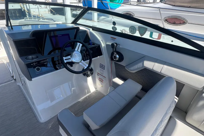 Slide: The Image of 2021 Sea Ray SDX 290 boat cockpit with modern steering and controls. - 3