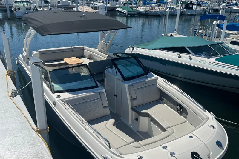 Slide: The Image of 2021 Sea Ray SDX 290 boat docked at marina, featuring sleek design and spacious seating. - 4