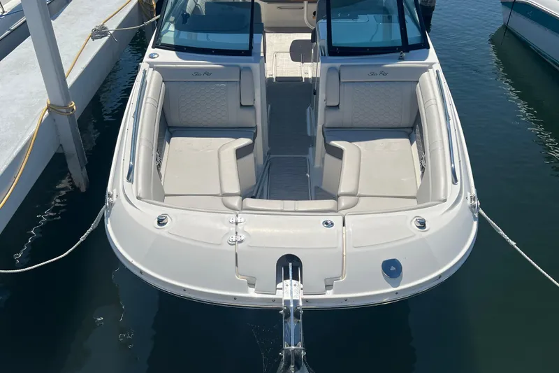 Slide: The Image of 2021 Sea Ray SDX 290 boat docked, featuring spacious seating and sleek design. - 5
