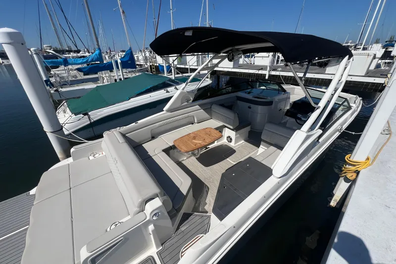 Slide: The Image of 2021 Sea Ray SDX 290 boat docked, featuring spacious seating and sleek design. - 6