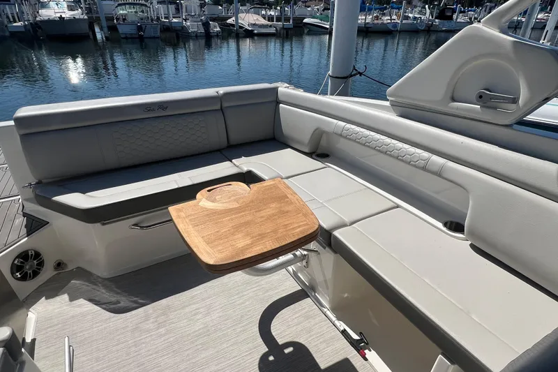 Slide: The Image of Luxurious 2021 Sea Ray SDX 290 boat interior with elegant seating and wooden table. - 8