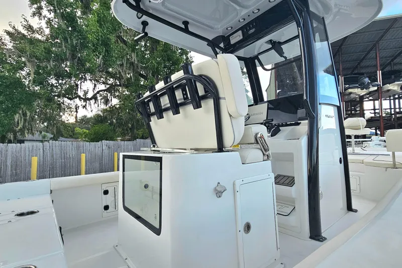 Slide: The Image of 2023 Sea Hunt BX 25 FS boat interior with seating and console, docked outdoors. - 12