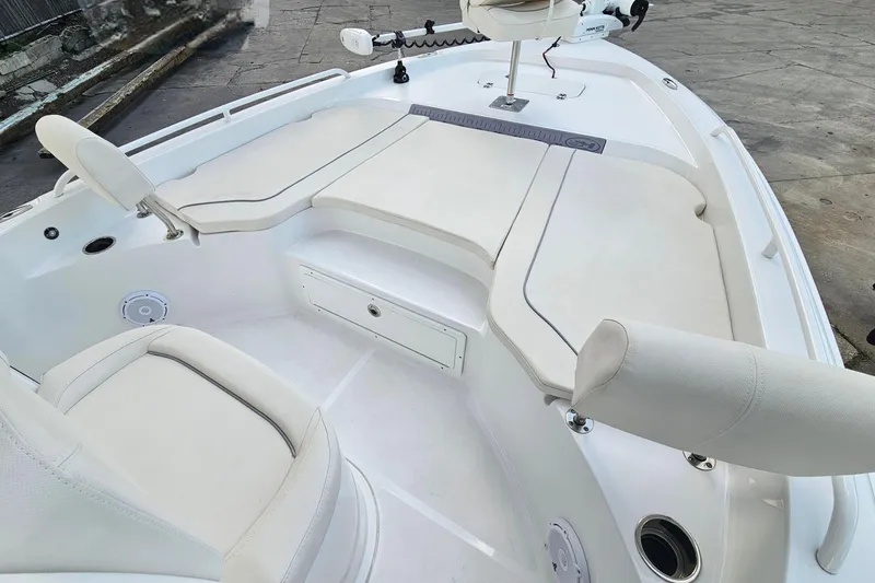 Slide: The Image of 2023 Sea Hunt BX 25 FS boat interior with cushioned seating and storage compartments. - 13