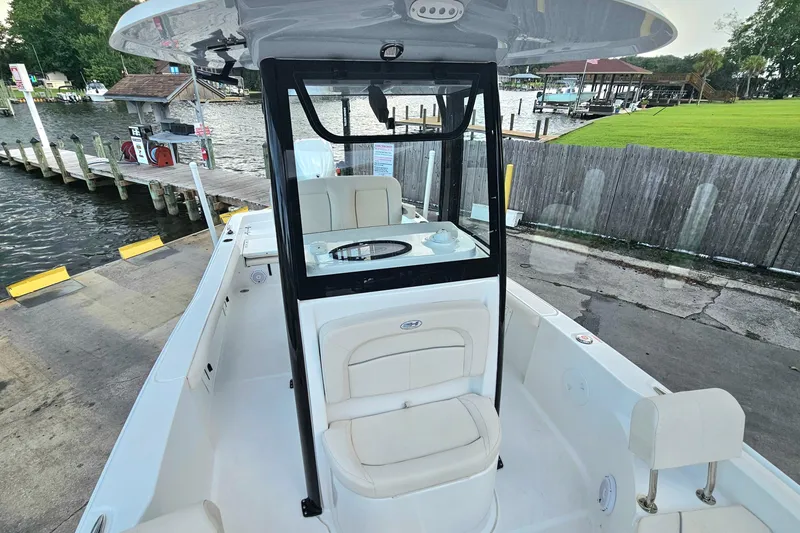 Slide: The Image of 2023 Sea Hunt BX 25 FS boat docked at a marina, showcasing interior seating. - 15