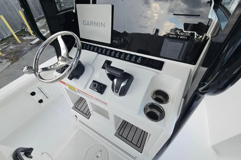 Slide: The Image of 2023 Sea Hunt BX 25 FS boat console with Garmin navigation and steering wheel. - 17