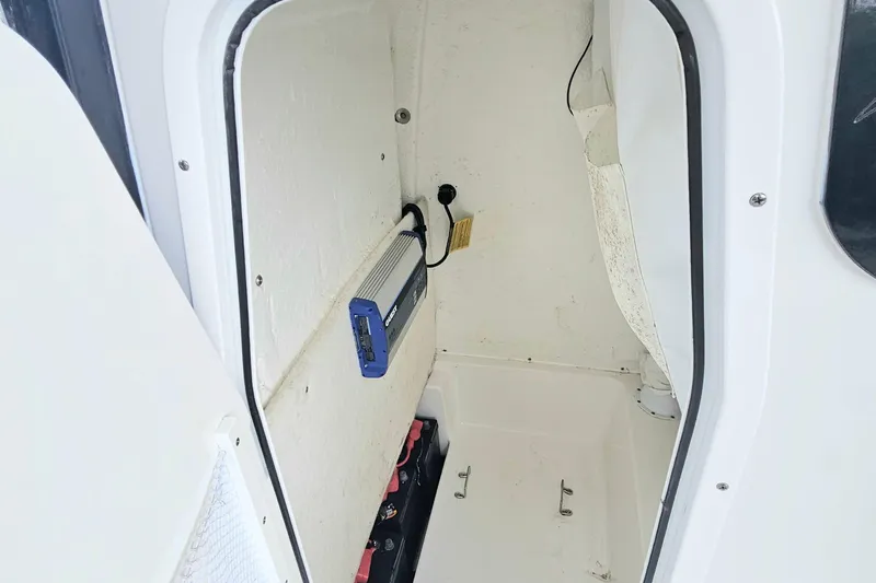 Slide: The Image of 2023 Sea Hunt BX 25 FS boat interior storage compartment with electronic equipment. - 19