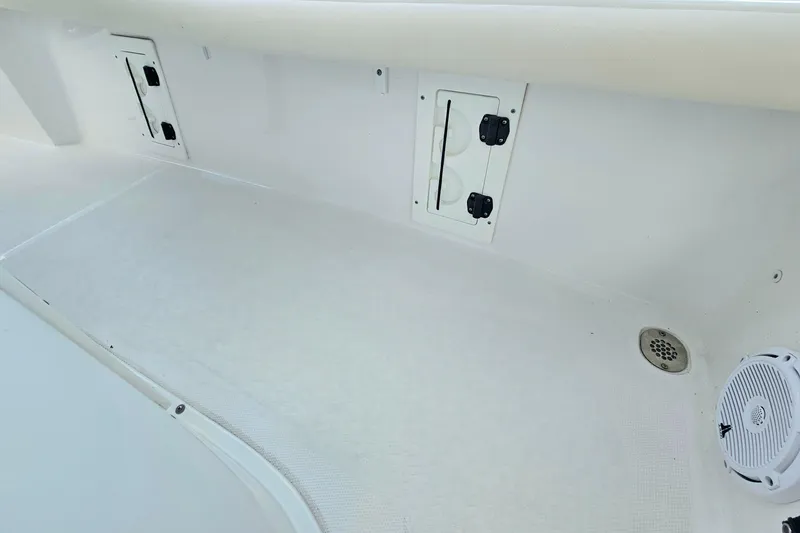 Slide: The Image of 2023 Sea Hunt BX 25 FS boat interior with storage compartments and speaker. - 23