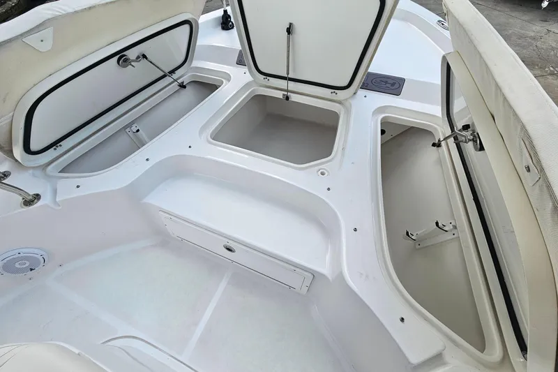 Slide: The Image of 2023 Sea Hunt BX 25 FS boat storage compartments open, showcasing spacious interior design. - 24