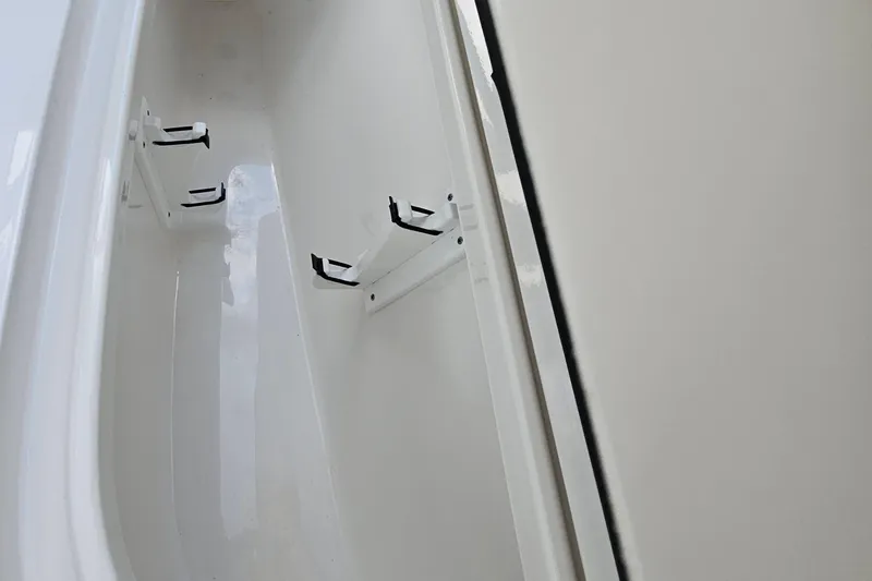 Slide: The Image of 2023 Sea Hunt BX 25 FS boat storage compartment with rod holders. - 25