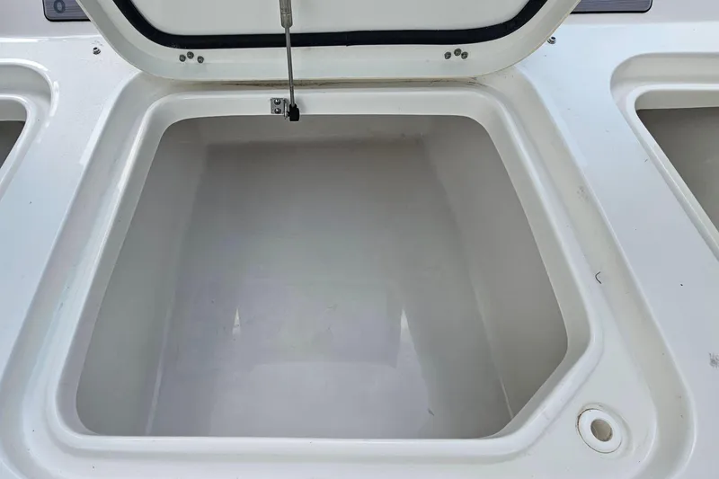 Slide: The Image of Open storage compartment on 2023 Sea Hunt BX 25 FS boat. - 26