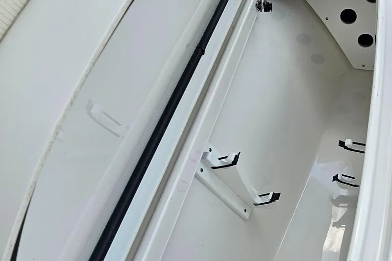 Slide: The Image of 2023 Sea Hunt BX 25 FS boat interior storage compartment with rod holders. - 27