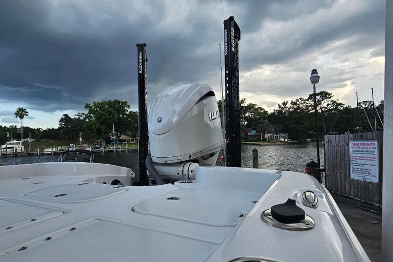 Slide: The Image of 2023 Sea Hunt BX 25 FS boat with Yamaha engine at a dock under cloudy skies. - 32