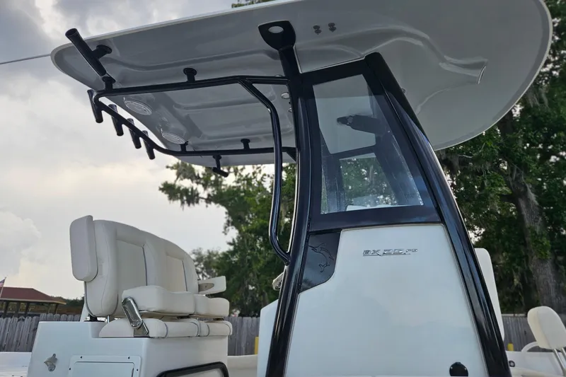 Slide: The Image of 2023 Sea Hunt BX 25 FS boat with T-top and seating, outdoors. - 8