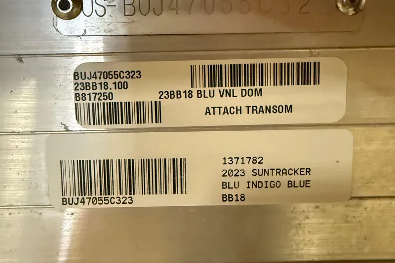 Slide: The Image of 2023 Sun Tracker Bass Buggy 18 DLX identification labels with barcodes and model details. - 6