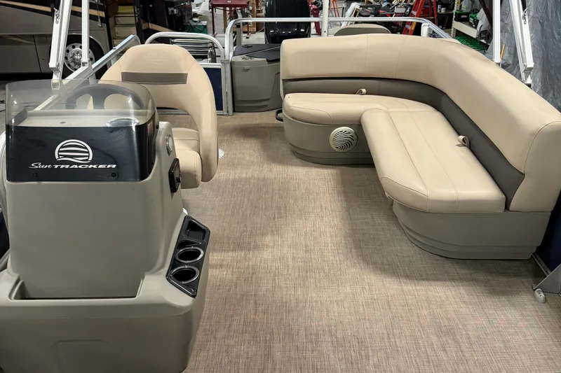 Slide: The Image of 2023 Sun Tracker Bass Buggy 18 DLX interior with beige seating and steering console. - 7