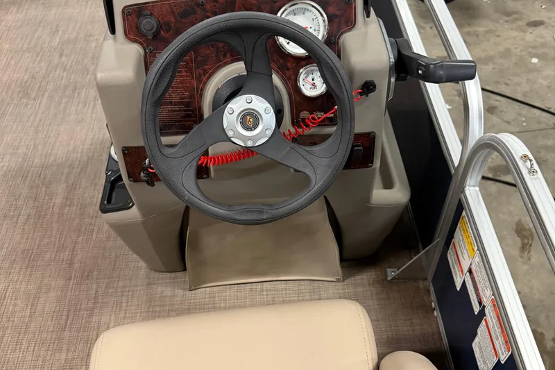 Slide: The Image of 2023 Sun Tracker Bass Buggy 18 DLX steering console with gauges and controls. - 8