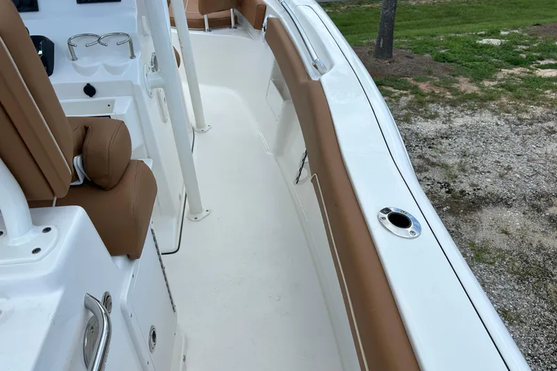 Slide: The Image of 2026 Key West 239 FS boat interior with tan seating and white deck. - 10