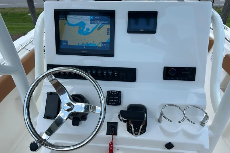 Slide: The Image of Key West 239 FS 2026 boat dashboard with steering wheel and navigation display. - 11