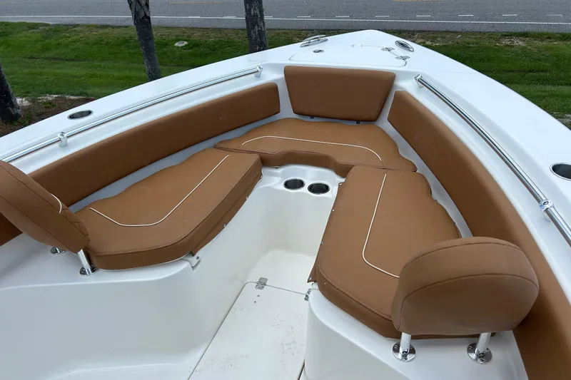 Slide: The Image of 2026 Key West 239 FS boat interior with tan seating and cup holders. - 13