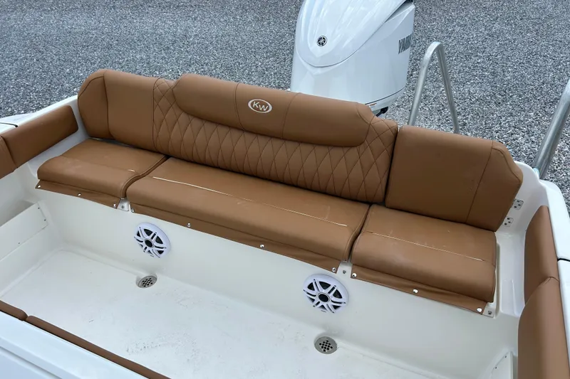 Slide: The Image of 2026 Key West 239 FS boat with tan cushioned seating and Yamaha engine. - 7
