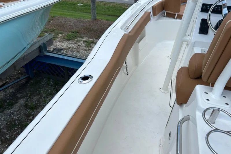 Slide: The Image of 2026 Key West 239 FS boat interior with tan seating and white deck. - 9