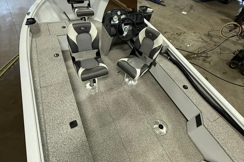 Slide: The Image of 2024 Polar Kraft Outlander 186 SC boat interior with seating and steering console. - 5