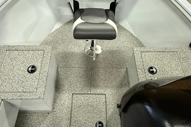 Slide: The Image of 2024 Polar Kraft Outlander 186 SC boat interior with gray flooring and a central swivel seat. - 6