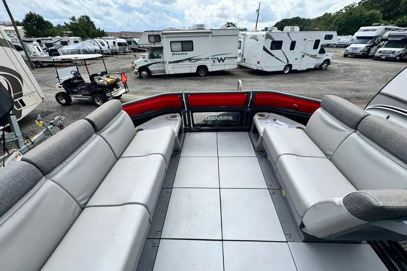 Slide: The Image of Interior of 2023 Sea-Doo Switch Cruise 21 with spacious seating, parked near RVs. - 11