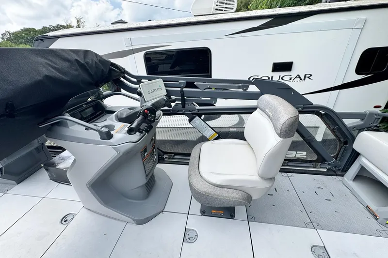 Slide: The Image of 2023 Sea-Doo Switch Cruise 21 interior with Garmin navigation system and comfortable seating. - 15