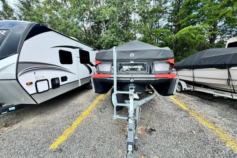Slide: The Image of 2023 Sea-Doo Switch Cruise 21 on trailer, parked between RV and boat, covered and secured. - 4