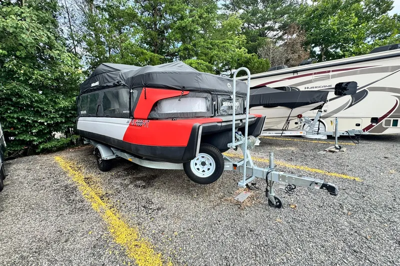 Slide: The Image of 2023 Sea-Doo Switch Cruise 21 on trailer, parked outdoors with trees and RV nearby. - 5