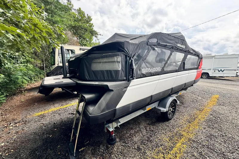 Slide: The Image of 2023 Sea-Doo Switch Cruise 21 on trailer, parked outdoors with cover. - 6