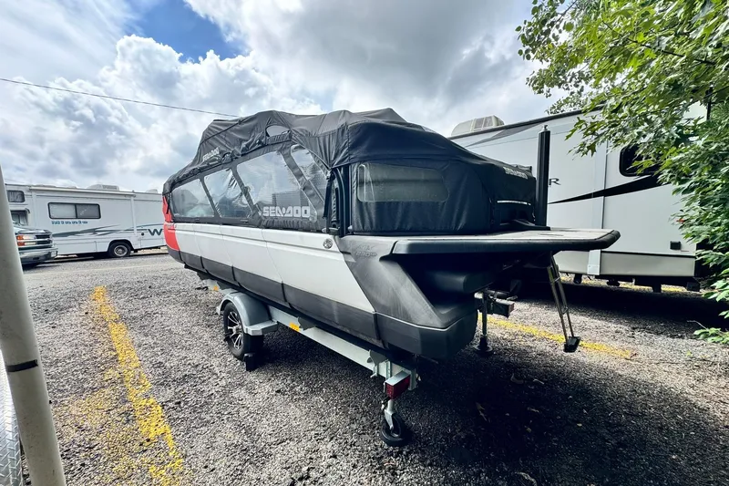 Slide: The Image of 2023 Sea-Doo Switch Cruise 21 boat on trailer, covered, parked outdoors. - 8