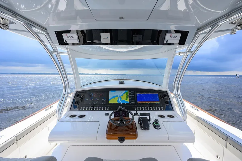 Slide: The Image of Cockpit view of 2026 Valhalla V-46 boat with advanced navigation systems on open water. - 23