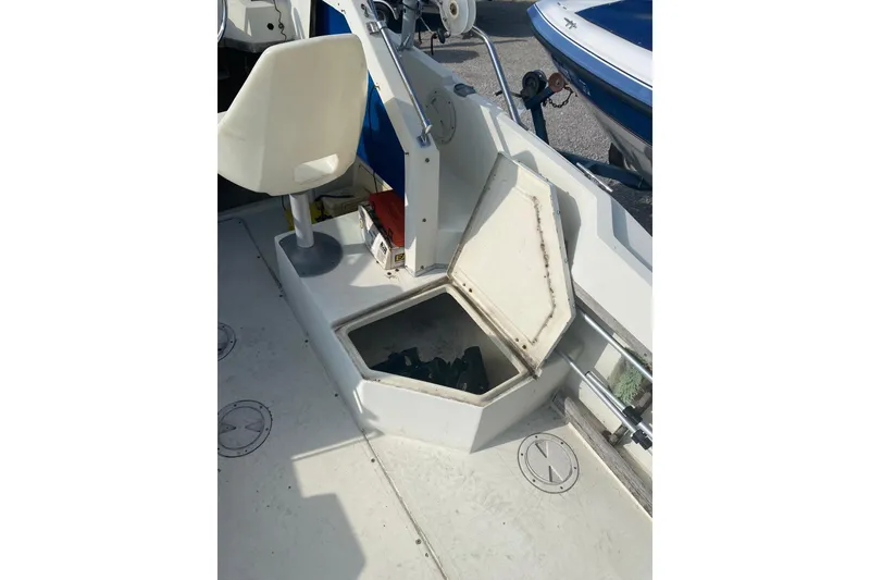 Slide: The Image of 1984 Hydra-Sports 2250 WA boat interior with open storage compartment and seating. - 12