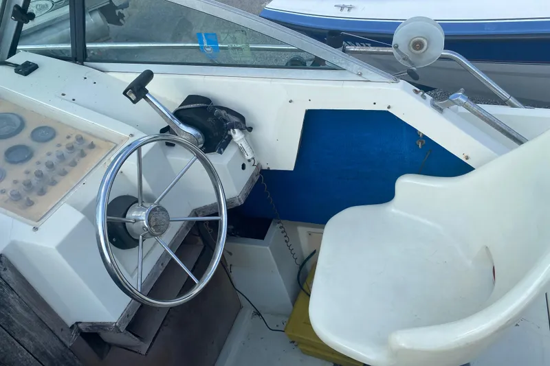 Slide: The Image of 1984 Hydra-Sports 2250 WA boat cockpit with steering wheel and control panel. - 20